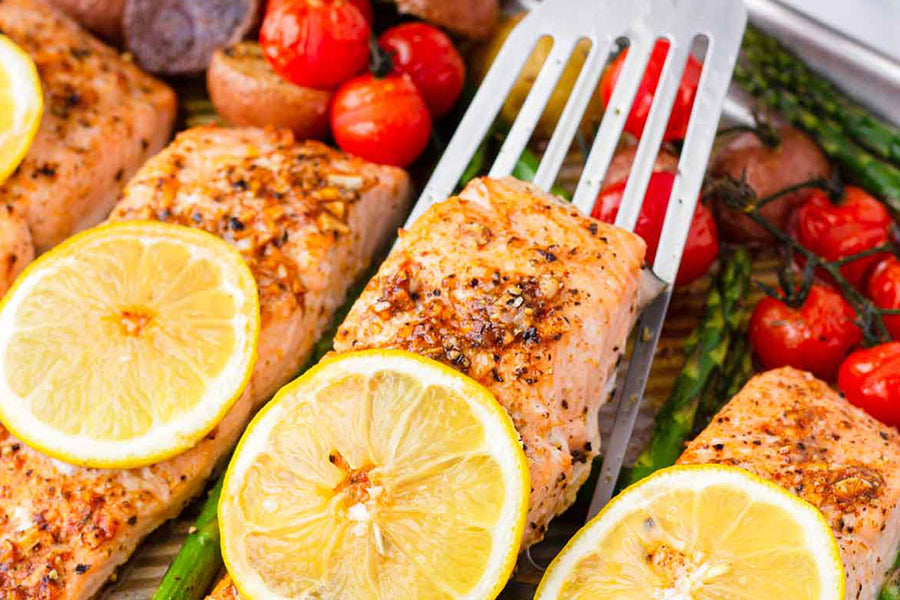 Zesty Lemon Herb Salmon Over a Rainbow of Roasted Veggies
