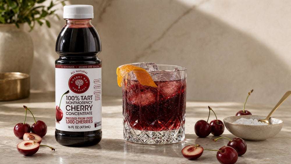 Cherry Bay Orchards Montmorency tart cherry concentrate beside a garnet cherry nightcap with orange peel
