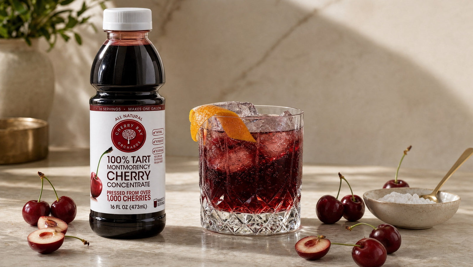 Cherry Bay Orchards Montmorency tart cherry concentrate beside a garnet cherry nightcap with orange peel