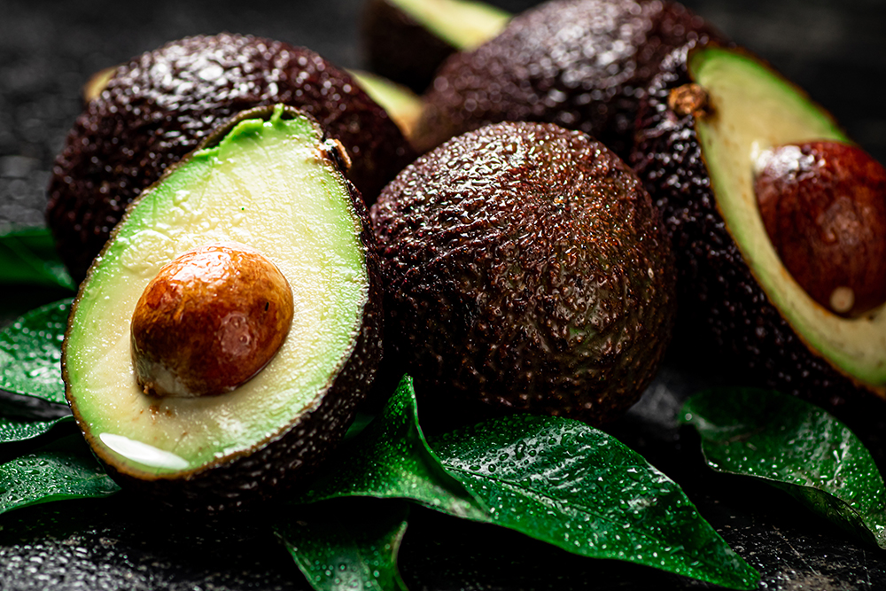 fresh avocado with leaves on a black background 2024 09 12 23 28 45 utc